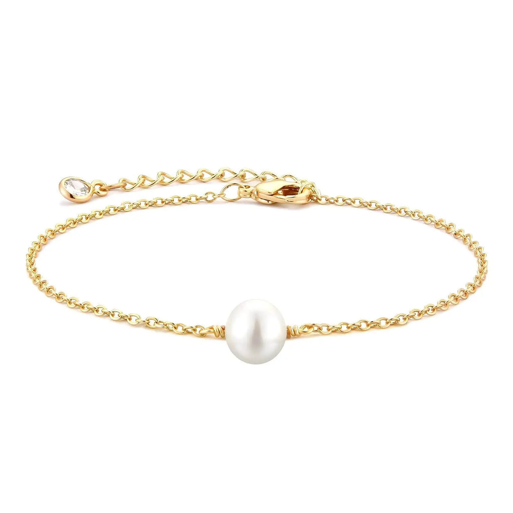 Gold bracelet with a single pearl on a white background