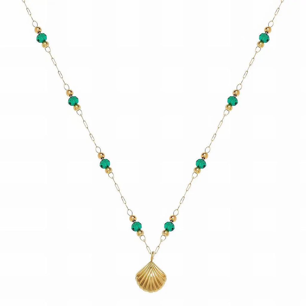 Necklace with green beads and a gold shell pendant on a white background