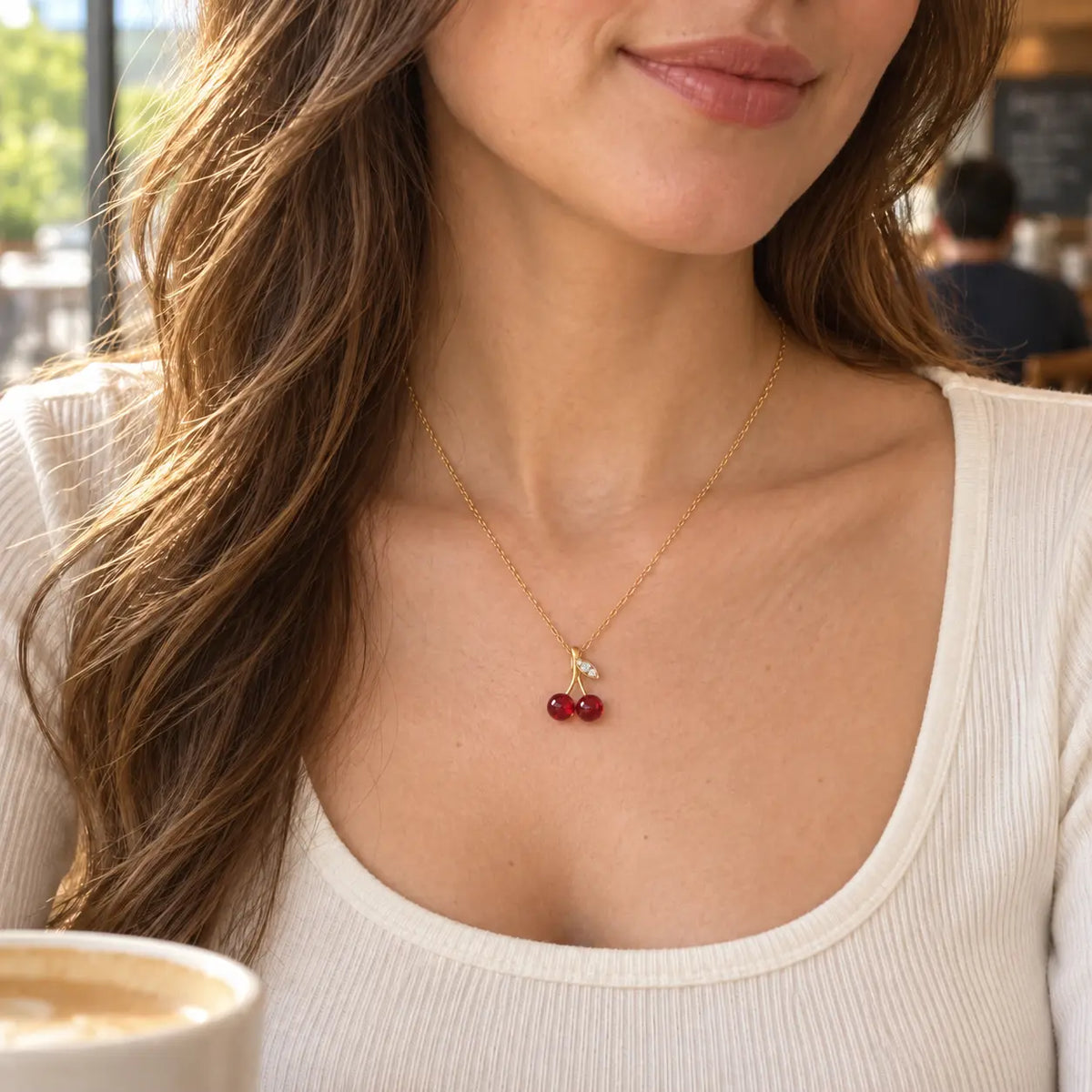 woman wearing a cherry pendant necklace