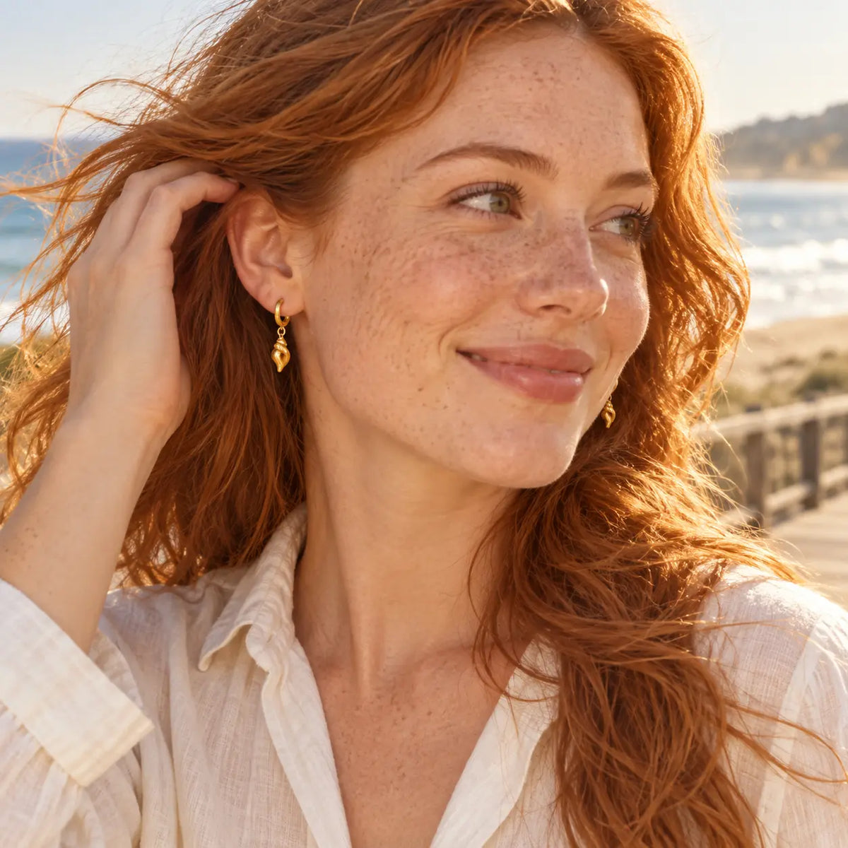 conch sea sheel earrings on redhead model