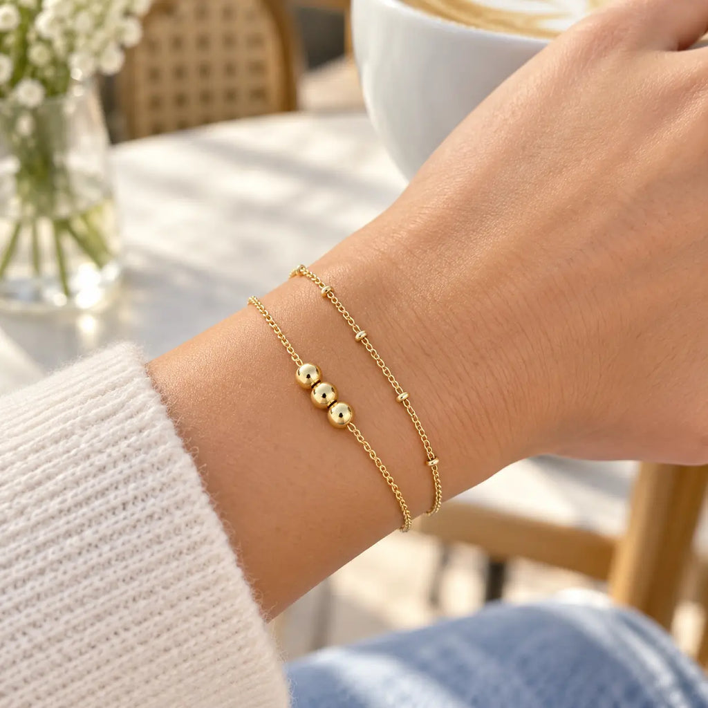 double gold bracelet on woman