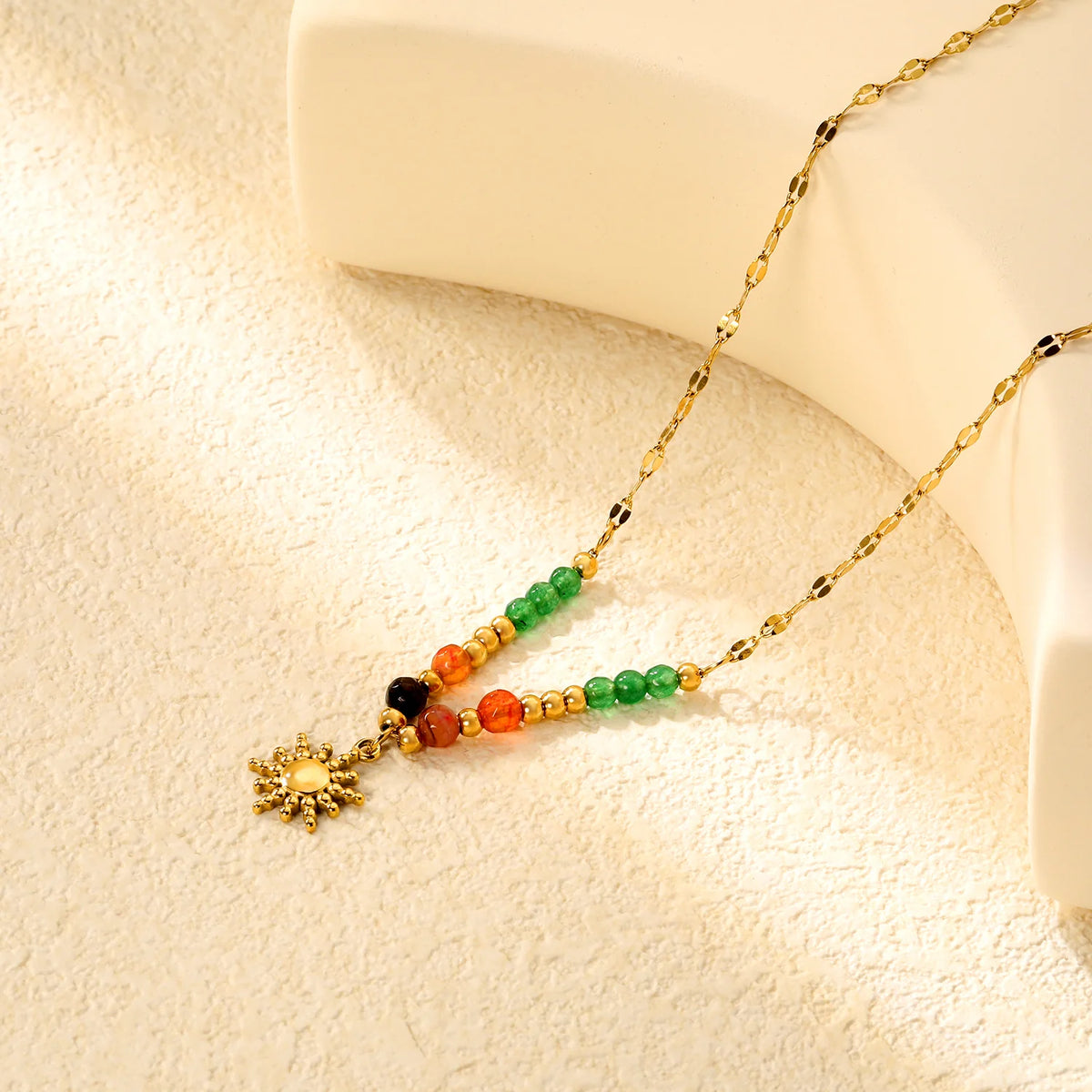 Multicolor Natural Stone Sun Pendant Necklace on tan background