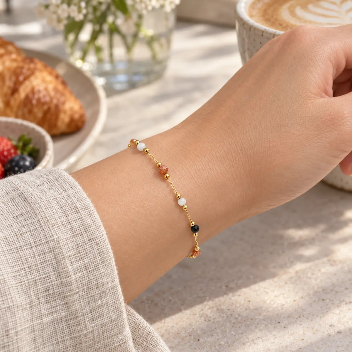 woman wearing natural stone bracelet at a cafe