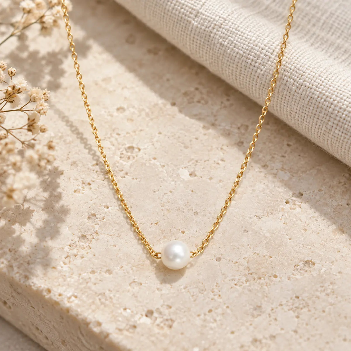 single round pearl necklace on rock