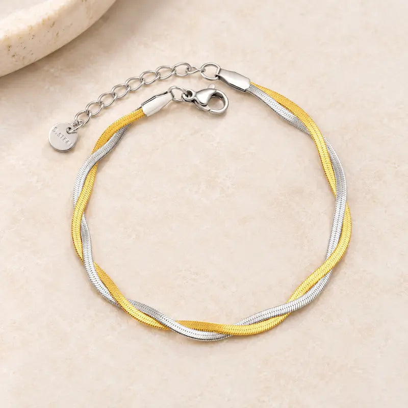 two tone gold and silver bracelet on a neutral background
