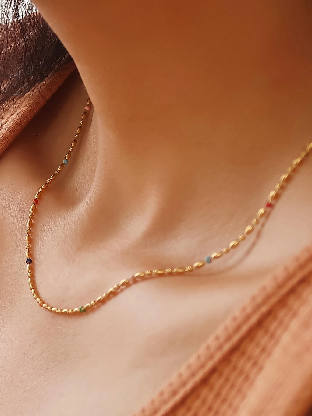 rainbow beaded gold chain on model