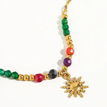 Close-up of multicolor beads and petite gold sun charm necklace
